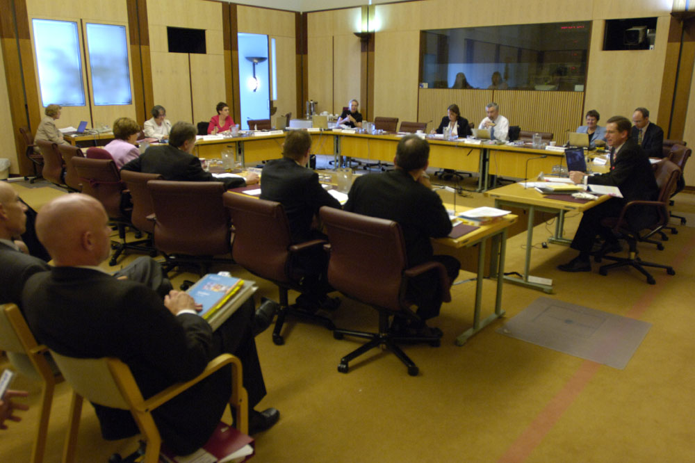 Members of the Community Affairs Legislation Committee questioning Senator the Hon Kay Patterson, Minister for Family and Community Services, and officers from the Department of Family and Community Services at a supplementary budget estimates hearing, 3 November 2005. Seated facing witnesses L-R: Senators Claire Moore [Deputy Chair], Helen Polley and Jan McLucas, Christine McDonald [Acting Secretary], Senators Gary Humphries [Chair], Judith Adams, Guy Barnett and Steve Fielding. DPS Auspic.