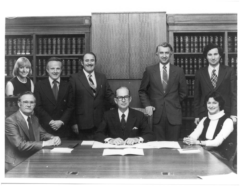 Standing Committee on Education and the Arts, ca1976-78. Inset: Senator Kathy Martin. Standing L-R: Senators John Button, Ted Robertson and Stan Collard, and Paul Barsdell [Research Officer]. Seated L-R: John Lipscombe [Secretary], Senators Gordon Davidson [Chair] and Susan Ryan.