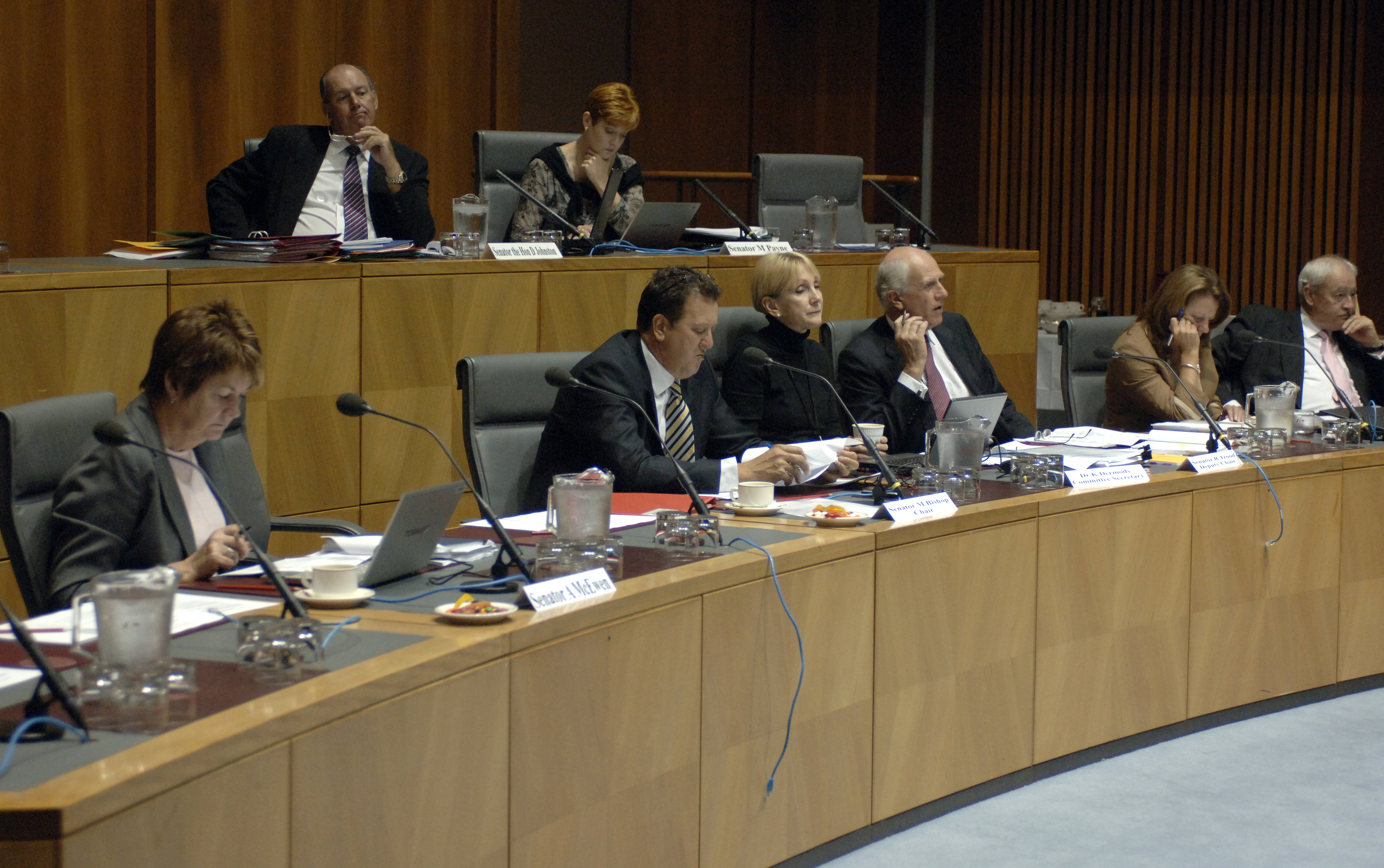 Standing Committee on Foreign Affairs, Defence and Trade, 25 February 2009. Top row L-R: Senators David Johnston and Marise Payne. Bottom row L-R: Senators Anne McEwen and Mark Bishop [Chair], Dr Kathleen Dermody [Secretary], Senators Russell Trood [Deputy Chair], Helen Kroger and Alan Ferguson. DPS Auspic.