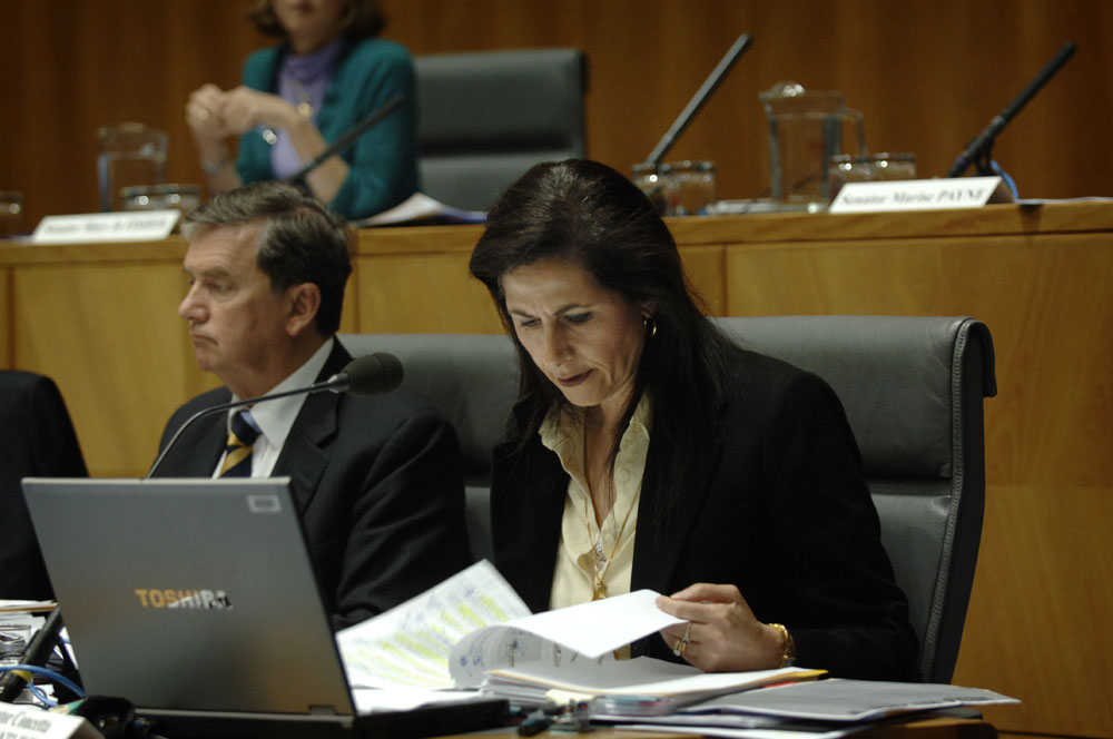 Senator Concetta Fierravanti-Wells examining documents during the supplementary budget estimates hearing, 21 October 2008. At left: Senator Chris Ellison. DPS Auspic. 