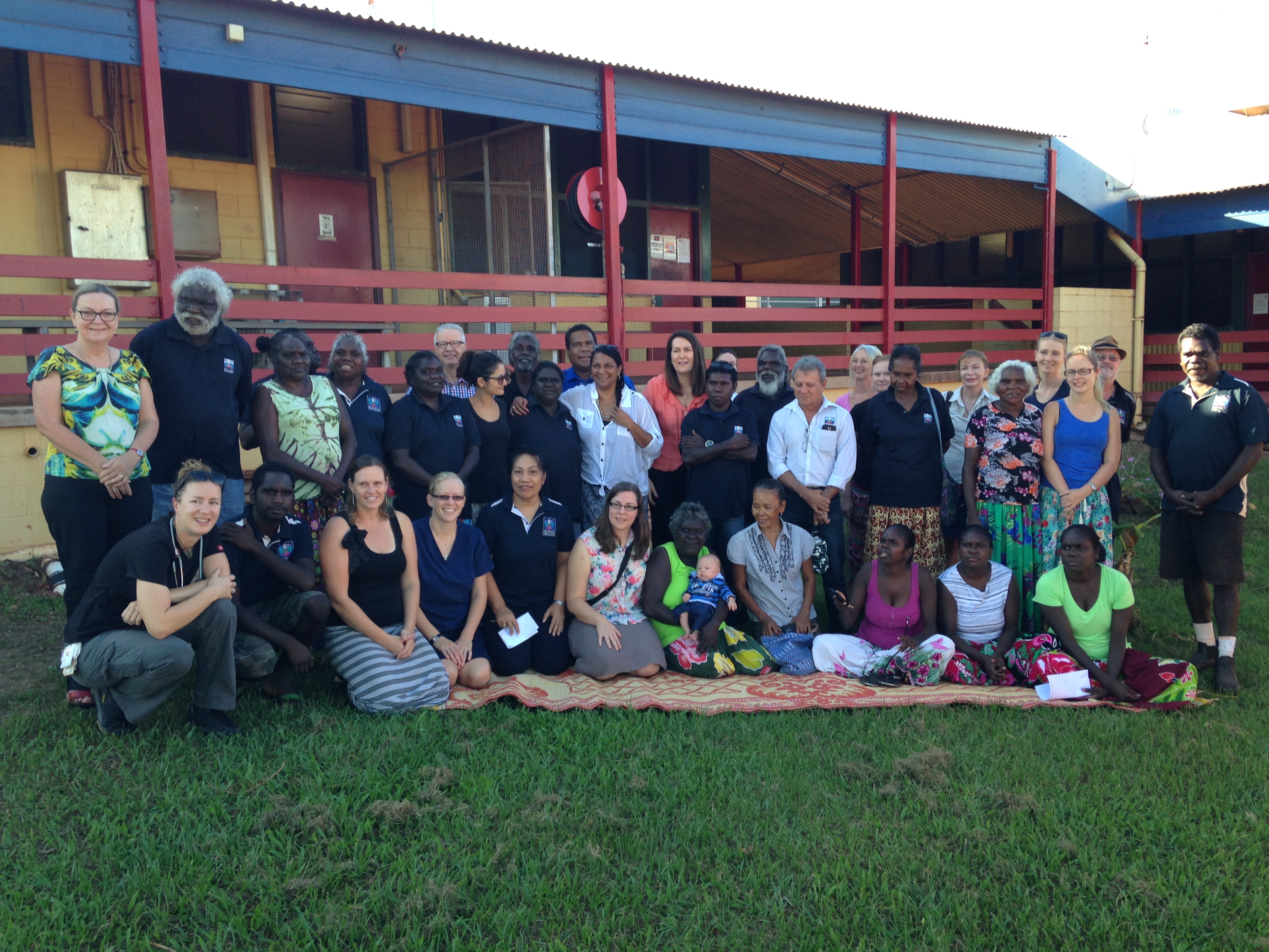 Committee members with staff from the Miwatj Health Service and Galiwin'ku community members outside the health centre, Elcho Island, NT, 30 April 2015. Includes Senators Deborah O'Neill [Chair], Jan McLucas, Doug Cameron and Nova Peris.