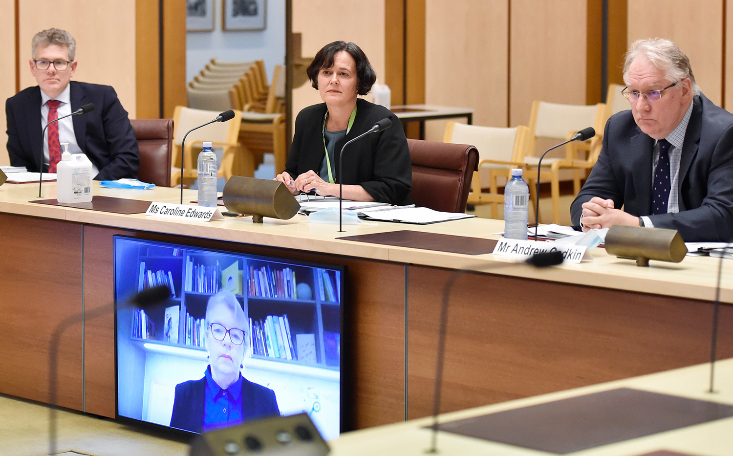 Health Department officials appearing before a hearing of the Select Committee on the Administration of Sports Grants, 27 August 2020. L-R facing camera: Mr Charles Wann, Ms Caroline Edwards and Mr Andrew Godkin, with Senator Rice [via video]. DPS Auspic 