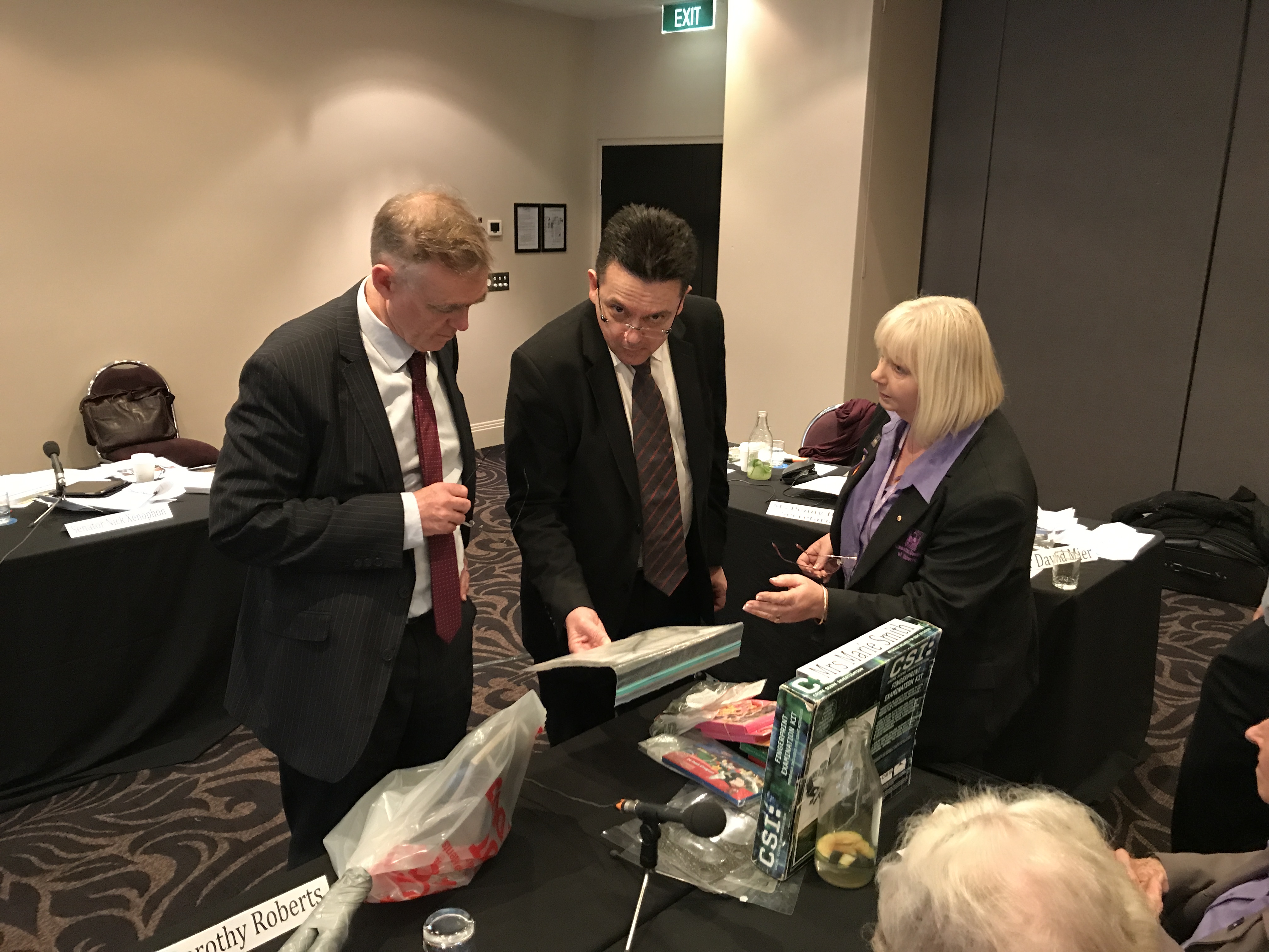 \x3cp\x3eL-R: Senators Chris Ketter [Chair], Nick Xenophon and Vicki Hamilton of the Asbestos Council of Victoria examine products containing asbestos at a hearing in Melbourne, 14 July 2017.\x3c/p\x3e