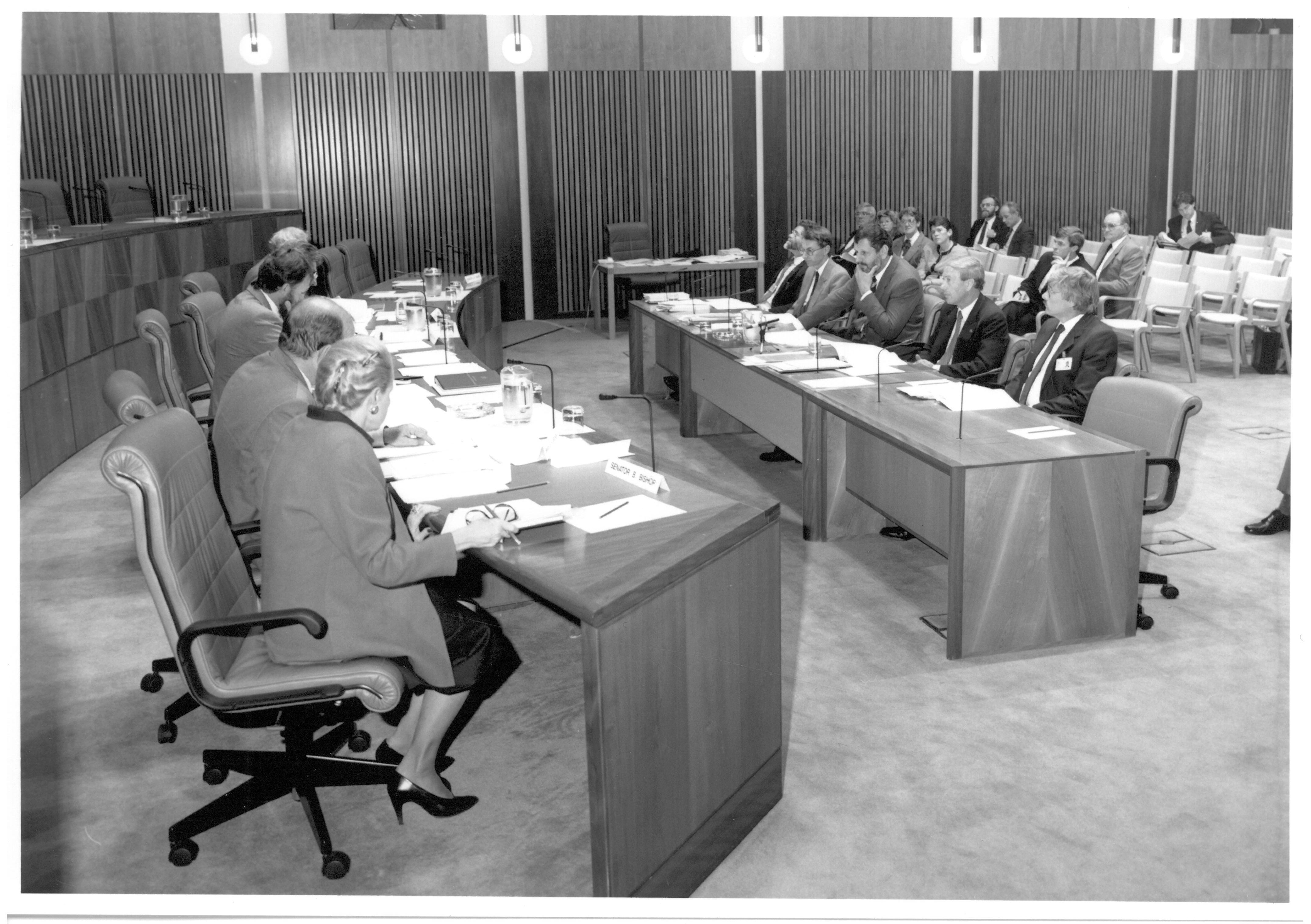 \x3cp\x3eEstimates Committee A questioning staff of the Department of the Senate, 14 May 1990. Seated on left, closest to farthest: Senators Bronwyn Bishop and Brian Archer, Peter Keele [Secretary], Senators Bruce Childs [Chair] and Bryant Burns. Seated at witness table L-R: Witnesses Peter O\'Keefe [Clerk Assistant (Committees)], Cleaver Elliott [Clerk Assistant (Procedure)], Harry Evans [Clerk of the Senate], Senator Kerry Sibraa [President of the Senate] and John Vander Wyk [Clerk Assistant (Management)].\x3c/p\x3e