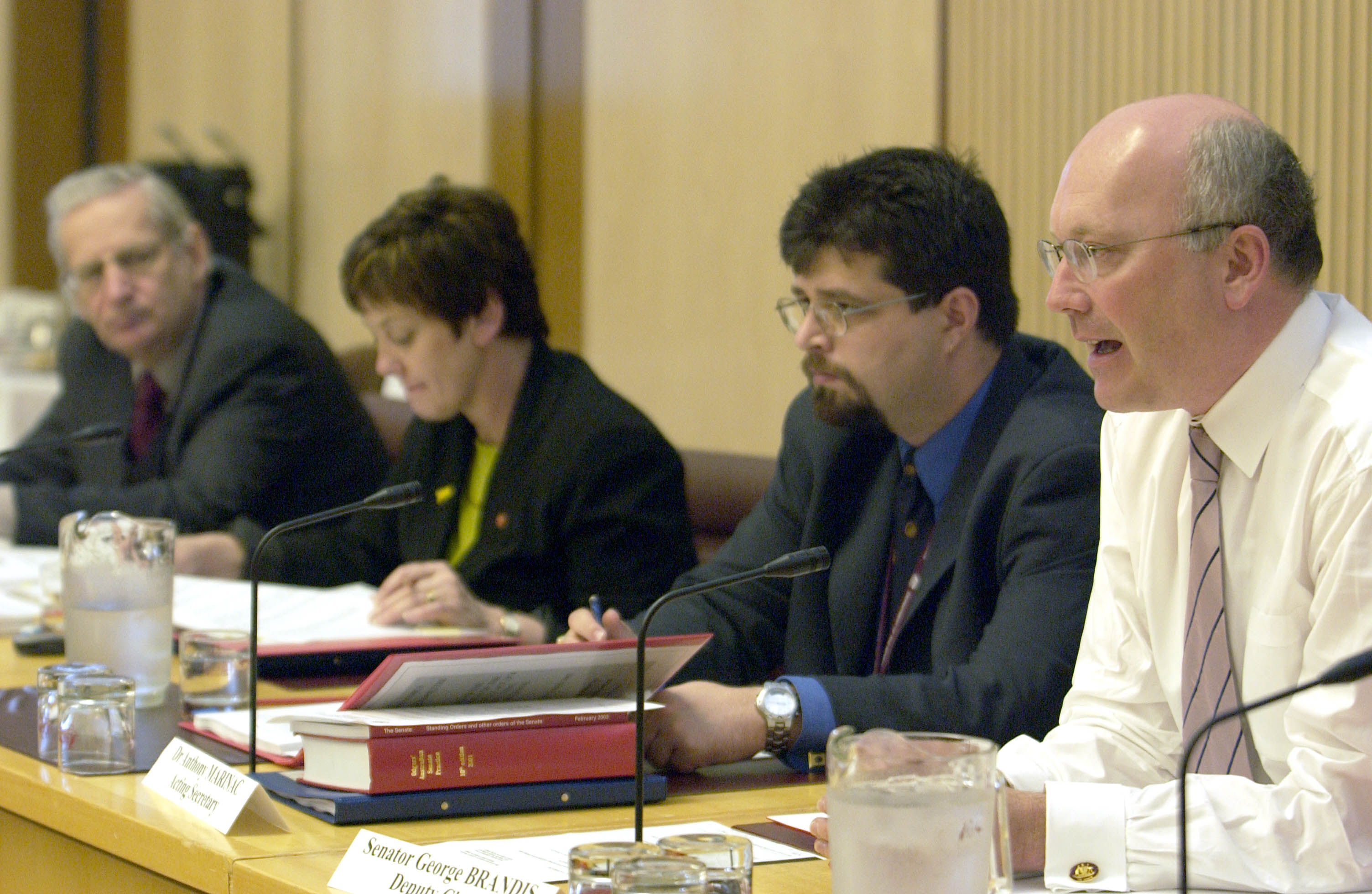\x3cp\x3eEconomics References Committee deputy chair Senator George Brandis [Deputy Chair] (right) questioning witnesses, 17 October 2003. Also L-R: Senators Geoff Buckland and Ursula Stephens [Chair] and Dr Anthony Marinac [Acting Secretary]. DPS Auspic.\x3c/p\x3e