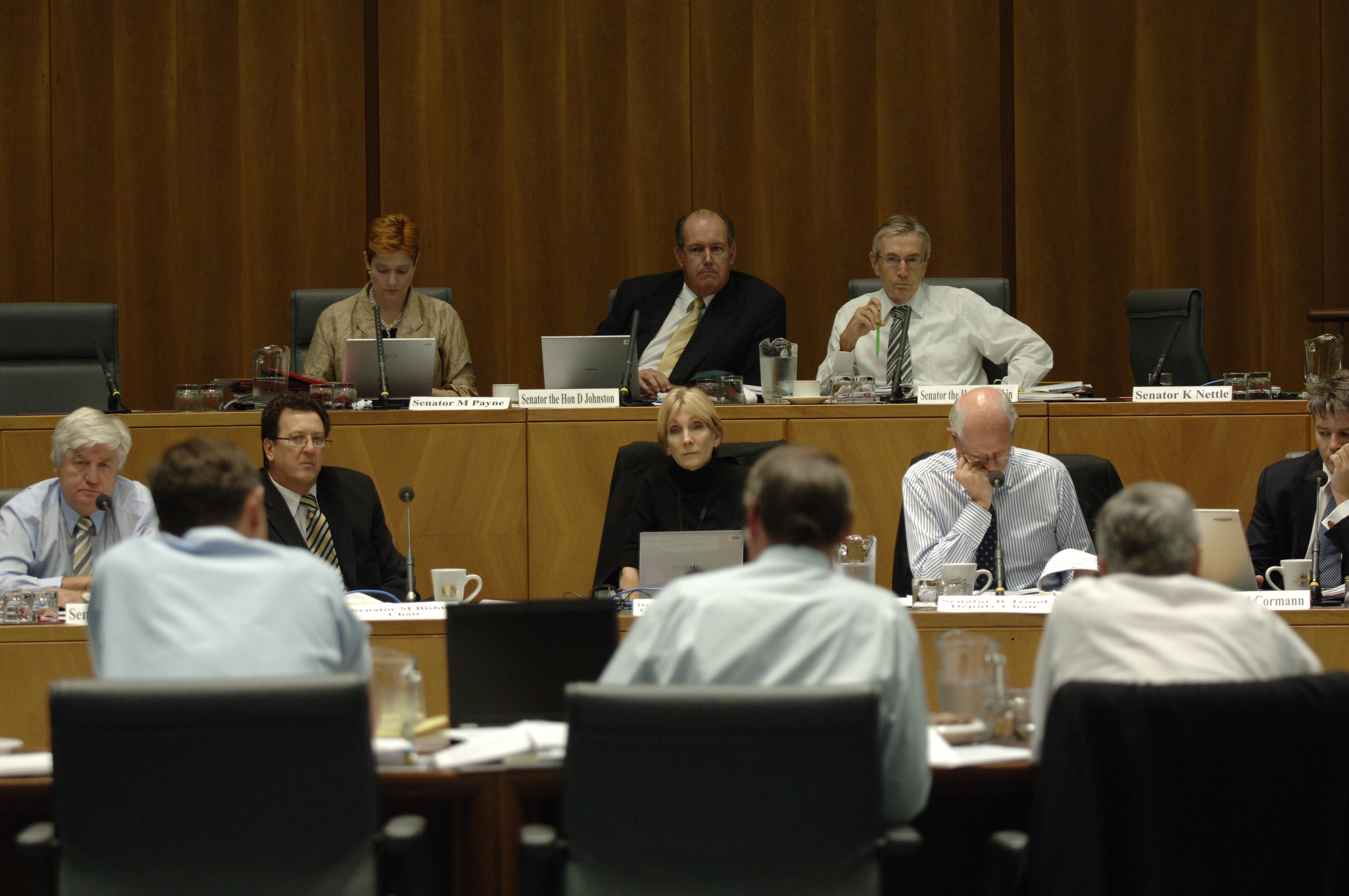 \x3cp\x3eStanding Committee on Foreign Affairs, Defence and Trade at an additional estimates hearing, 20 February 2008. Top row facing camera L-R: Senators Marise Payne, David Johnston and Nick Minchin. Bottom row facing camera L-R: Senators Michael Forshaw and Mark Bishop [Chair], Dr Kathleen Dermody [Secretary], Senators Russell Trood [Deputy Chair] and Mathias Cormann. DPS Auspic.\x3c/p\x3e